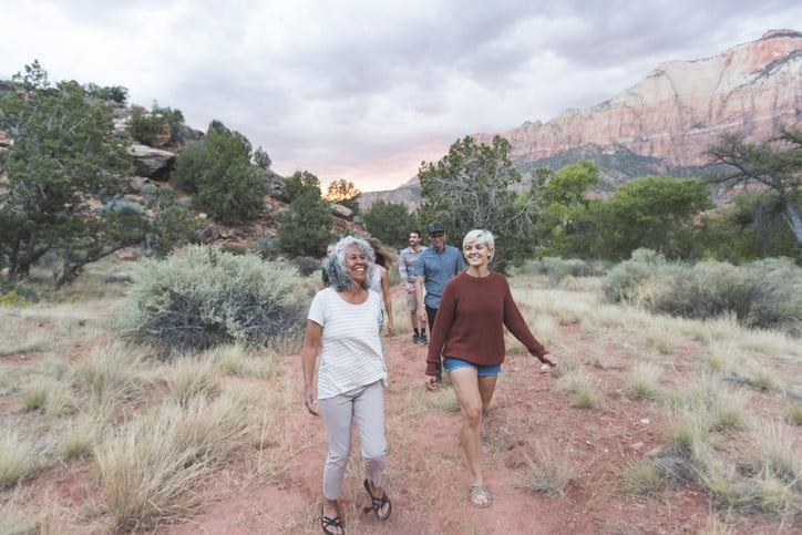 A group of seniors go for a day hike during the summer in the mountains