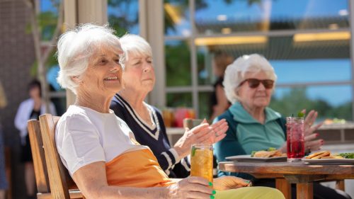 The Ridge Foothill women sitting in the sun with drinks.