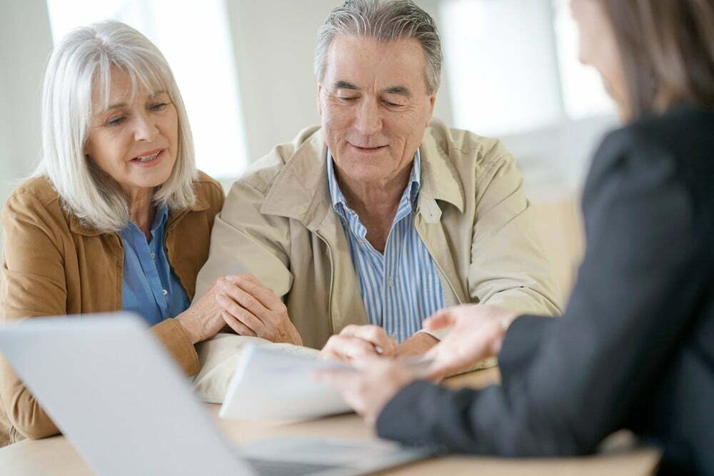 Senior couple talking with financial planner