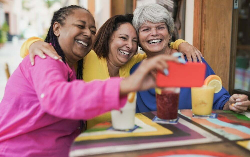 Senior women taking a selfie at lunch
